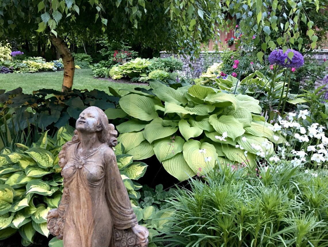 Statue of girl with hostas